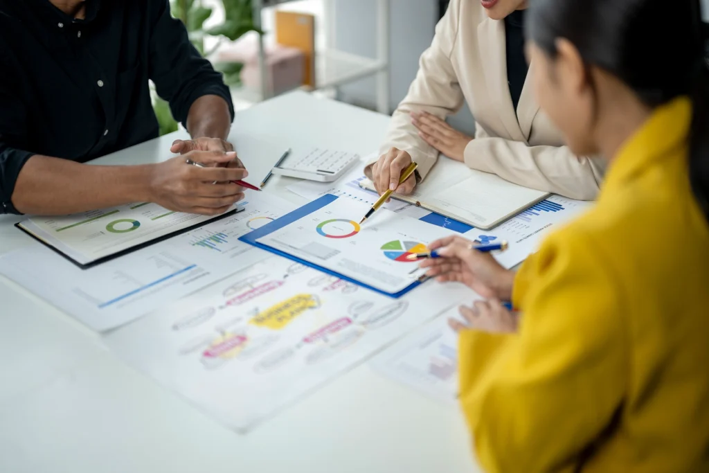 people sitting at a table with papers